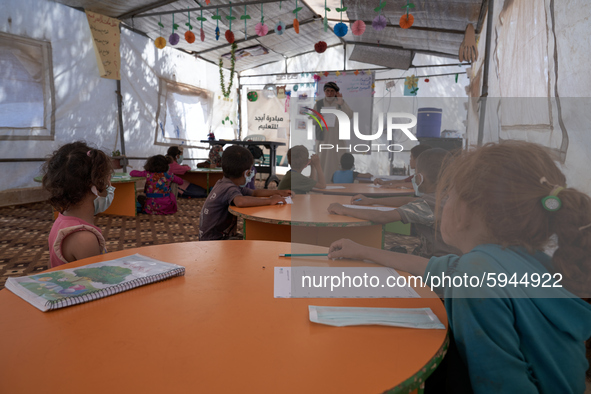 Syrian students take a math lesson in a refugee camp near Syrian-Turkish borders in Idlib, Syria, on August 25, 2020. 