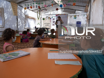 Syrian students take a math lesson in a refugee camp near Syrian-Turkish borders in Idlib, Syria, on August 25, 2020. (