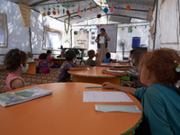 Syrian students take a math lesson in a refugee camp near Syrian-Turkish borders in Idlib, Syria, on August 25, 2020. (