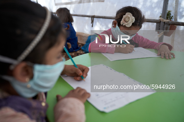 Syrian students take a math lesson in a refugee camp near Syrian-Turkish borders in Idlib, Syria, on August 25, 2020. 