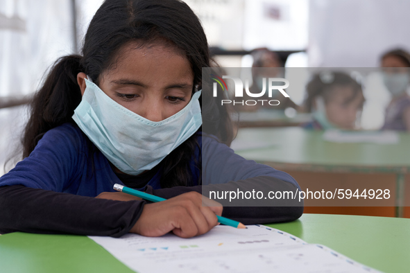 Syrian students take a math lesson in a refugee camp near Syrian-Turkish borders in Idlib, Syria, on August 25, 2020. 