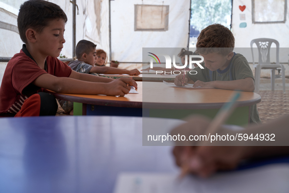 Syrian students take a math lesson in a refugee camp near Syrian-Turkish borders in Idlib, Syria, on August 25, 2020. 