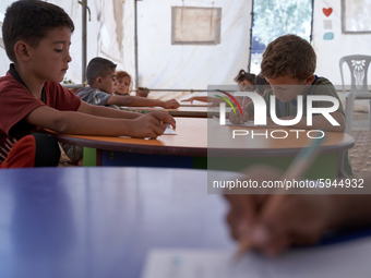 Syrian students take a math lesson in a refugee camp near Syrian-Turkish borders in Idlib, Syria, on August 25, 2020. (