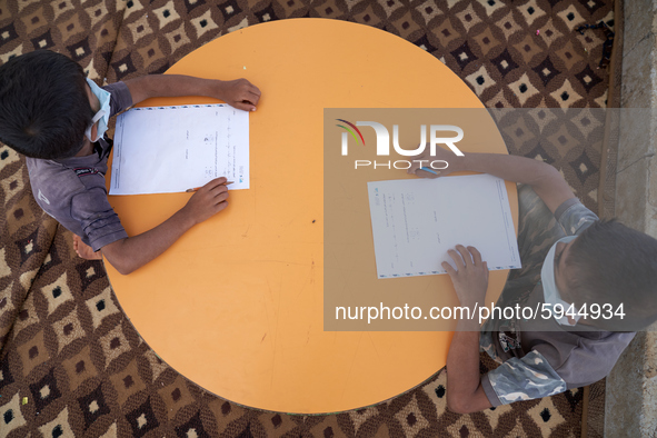 Syrian students take a math lesson in a refugee camp near Syrian-Turkish borders in Idlib, Syria, on August 25, 2020. 