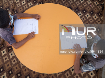 Syrian students take a math lesson in a refugee camp near Syrian-Turkish borders in Idlib, Syria, on August 25, 2020. (