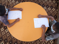 Syrian students take a math lesson in a refugee camp near Syrian-Turkish borders in Idlib, Syria, on August 25, 2020. (