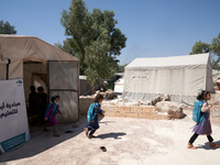 Syrian students leave the educational tent after taking a math lesson in a refugee camp near Syrian-Turkish borders in Idlib, Syria, on Augu...