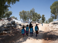 Syrian students leave the educational tent after taking a math lesson in a refugee camp near Syrian-Turkish borders in Idlib, Syria, on Augu...