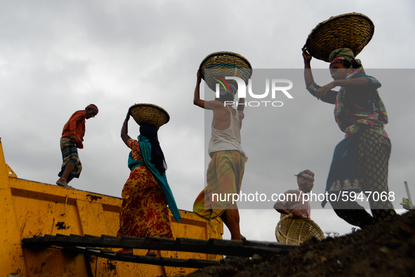 Day laborers unload sand from a cargo ship in Dhaka, Bangladesh on August 26, 2020. Dhaka is getting back to its normal life after months of...