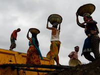 Day laborers unload sand from a cargo ship in Dhaka, Bangladesh on August 26, 2020. Dhaka is getting back to its normal life after months of...