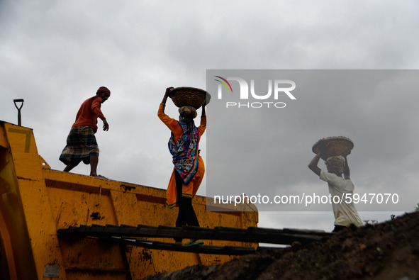 Day laborers unload sand from a cargo ship in Dhaka, Bangladesh on August 26, 2020. Dhaka is getting back to its normal life after months of...