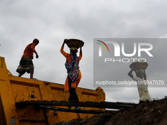 Day laborers unload sand from a cargo ship in Dhaka, Bangladesh on August 26, 2020. Dhaka is getting back to its normal life after months of...