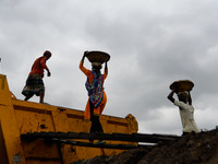 Day laborers unload sand from a cargo ship in Dhaka, Bangladesh on August 26, 2020. Dhaka is getting back to its normal life after months of...