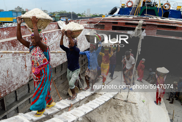 Day laborers unload sand from a cargo ship in Dhaka, Bangladesh on August 26, 2020. Dhaka is getting back to its normal life after months of...