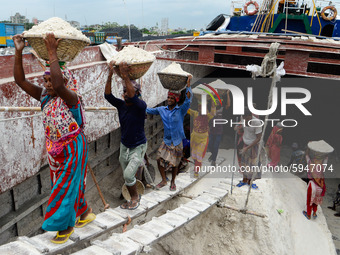 Day laborers unload sand from a cargo ship in Dhaka, Bangladesh on August 26, 2020. Dhaka is getting back to its normal life after months of...