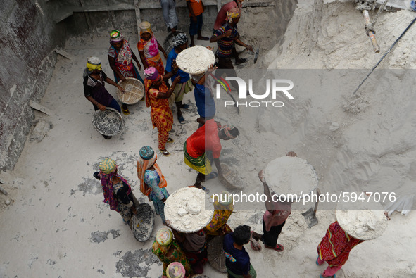 Day laborers unload sand from a cargo ship in Dhaka, Bangladesh on August 26, 2020. Dhaka is getting back to its normal life after months of...