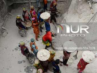 Day laborers unload sand from a cargo ship in Dhaka, Bangladesh on August 26, 2020. Dhaka is getting back to its normal life after months of...