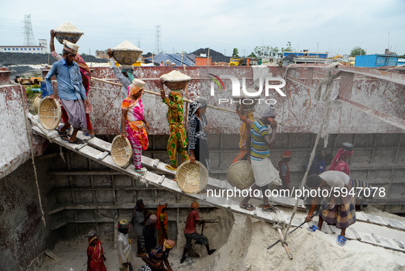 Day laborers unload sand from a cargo ship in Dhaka, Bangladesh on August 26, 2020. Dhaka is getting back to its normal life after months of...