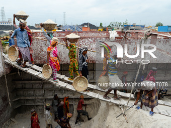 Day laborers unload sand from a cargo ship in Dhaka, Bangladesh on August 26, 2020. Dhaka is getting back to its normal life after months of...