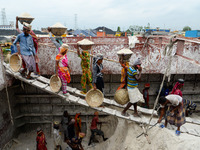 Day laborers unload sand from a cargo ship in Dhaka, Bangladesh on August 26, 2020. Dhaka is getting back to its normal life after months of...