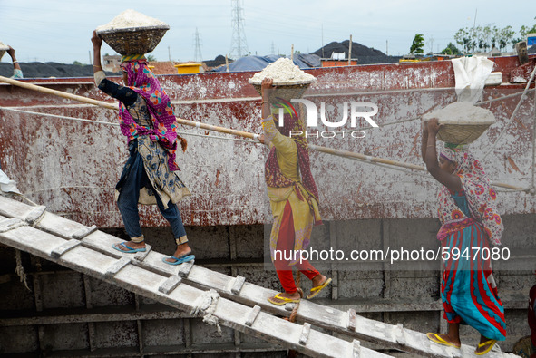 Day laborers unload sand from a cargo ship in Dhaka, Bangladesh on August 26, 2020. Dhaka is getting back to its normal life after months of...