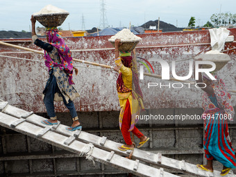 Day laborers unload sand from a cargo ship in Dhaka, Bangladesh on August 26, 2020. Dhaka is getting back to its normal life after months of...