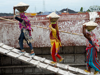 Day laborers unload sand from a cargo ship in Dhaka, Bangladesh on August 26, 2020. Dhaka is getting back to its normal life after months of...