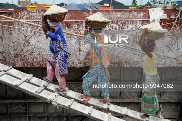 Day laborers unload sand from a cargo ship in Dhaka, Bangladesh on August 26, 2020. Dhaka is getting back to its normal life after months of...