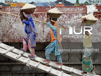 Day laborers unload sand from a cargo ship in Dhaka, Bangladesh on August 26, 2020. Dhaka is getting back to its normal life after months of...