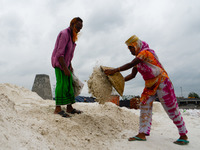 Day laborers unload sand from a cargo ship in Dhaka, Bangladesh on August 26, 2020. Dhaka is getting back to its normal life after months of...