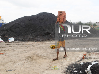 Day laborers unload sand from a cargo ship in Dhaka, Bangladesh on August 26, 2020. Dhaka is getting back to its normal life after months of...