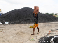 Day laborers unload sand from a cargo ship in Dhaka, Bangladesh on August 26, 2020. Dhaka is getting back to its normal life after months of...