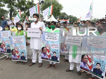 Students and Member of Trinamool Congress Chharta Parisad (TMCP) holds posters during a protest against the Union Government conducting JEE...