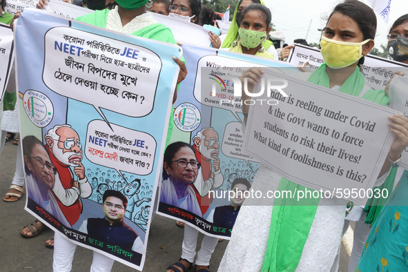 Students and Member of Trinamool Congress Chharta Parisad (TMCP) holds posters during a protest against the Union Government conducting JEE...