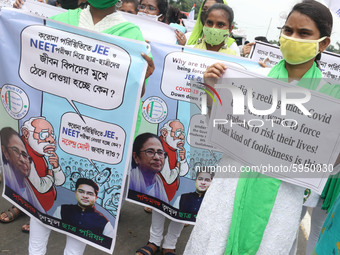 Students and Member of Trinamool Congress Chharta Parisad (TMCP) holds posters during a protest against the Union Government conducting JEE...