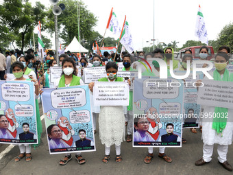 Students and Member of Trinamool Congress Chharta Parisad (TMCP) holds posters during a protest against the Union Government conducting JEE...