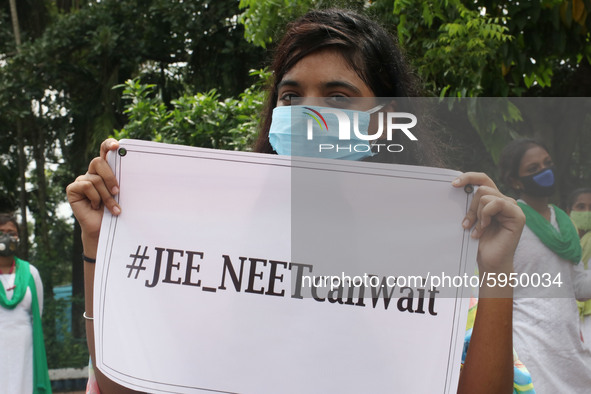 Students and Member of Trinamool Congress Chharta Parisad (TMCP) holds posters during a protest against the Union Government conducting JEE...