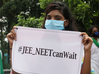 Students and Member of Trinamool Congress Chharta Parisad (TMCP) holds posters during a protest against the Union Government conducting JEE...