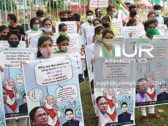 Students and Member of Trinamool Congress Chharta Parisad (TMCP) holds posters during a protest against the Union Government conducting JEE...