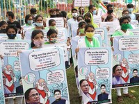 Students and Member of Trinamool Congress Chharta Parisad (TMCP) holds posters during a protest against the Union Government conducting JEE...