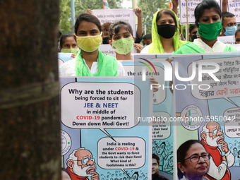 Students and Member of Trinamool Congress Chharta Parisad (TMCP) holds posters during a protest against the Union Government conducting JEE...