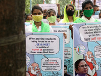 Students and Member of Trinamool Congress Chharta Parisad (TMCP) holds posters during a protest against the Union Government conducting JEE...