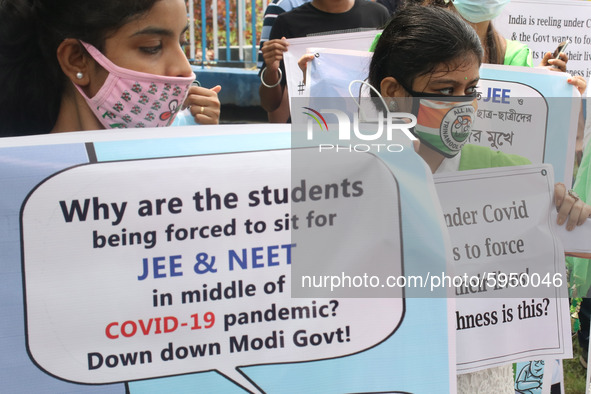 Students and Member of Trinamool Congress Chharta Parisad (TMCP) holds posters during a protest against the Union Government conducting JEE...