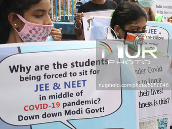 Students and Member of Trinamool Congress Chharta Parisad (TMCP) holds posters during a protest against the Union Government conducting JEE...