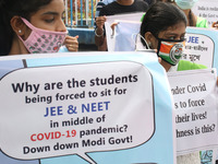 Students and Member of Trinamool Congress Chharta Parisad (TMCP) holds posters during a protest against the Union Government conducting JEE...