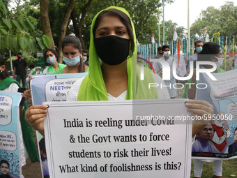 Students and Member of Trinamool Congress Chharta Parisad (TMCP) holds posters during a protest against the Union Government conducting JEE...