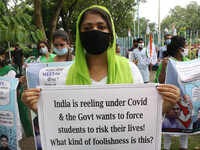 Students and Member of Trinamool Congress Chharta Parisad (TMCP) holds posters during a protest against the Union Government conducting JEE...