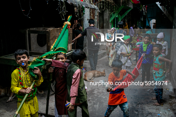 Young Biharis carry flying banners and play with them inside the geneva camp in Dhaka, Bangladesh, on August 29, 2020. 