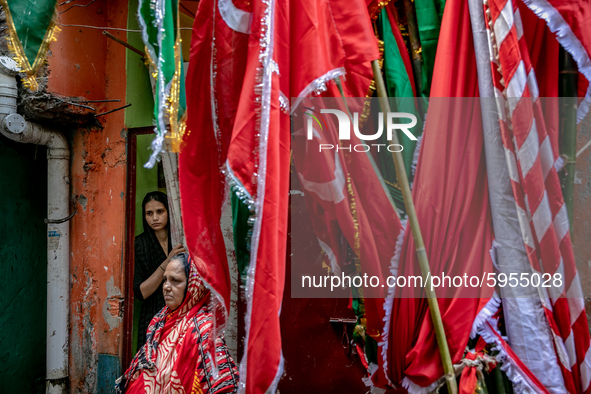 Women watches the preparation of the muharram celebration from the house inside the geneva camp in Dhaka, Bangladesh, on August 29, 2020.  