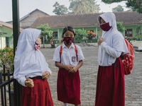 Students gather before entering the classroom at Candirejo Elementary School, Semarang Regency, Central Java, Indonesia, on September 1, 202...